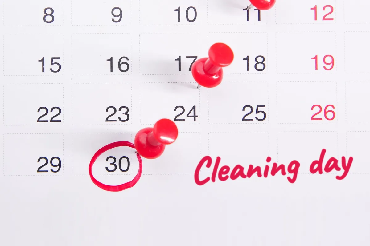A calendar with a date circled in red and the words Cleaning day