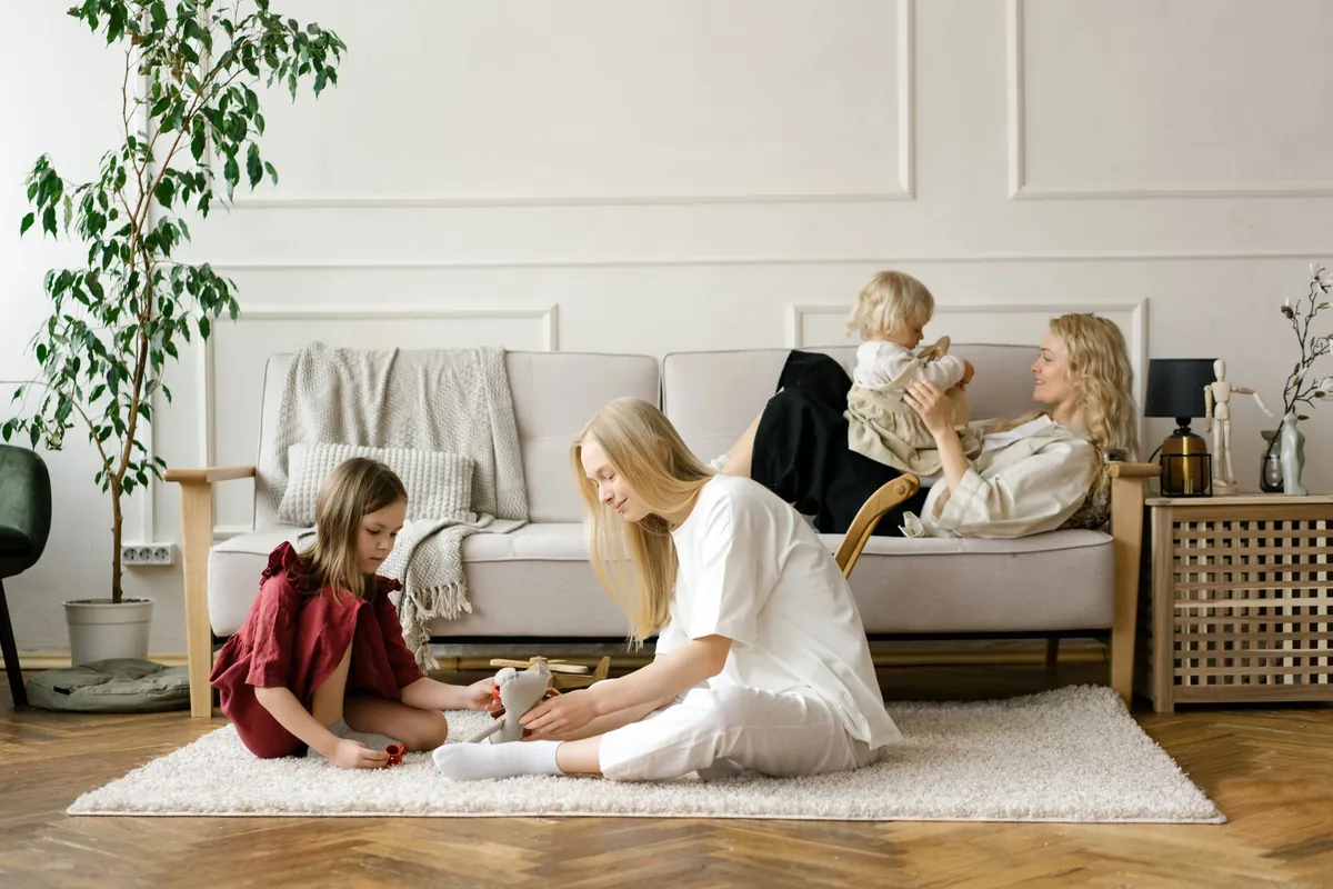 A family playing together in a bright, tidy living room